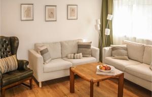 a living room with two couches and a coffee table at Fewo Albrechtshof in Ribnitz-Damgarten