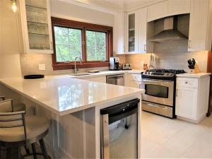 a kitchen with a counter and a stove top oven at Nature's Luxe Retreat - Panache 638 in Mont-Tremblant