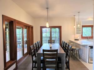 a kitchen and dining room with a table and chairs at Nature's Luxe Retreat - Panache 638 in Mont-Tremblant