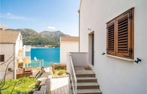a stairway leading up to a white building with a window at Lovely Apartment In Slano With Wifi in Slano +21 photos