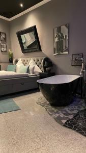 a large bath tub in a room with a bed at City Apartments Trier-Karl-Marx Suite 1 in Trier
