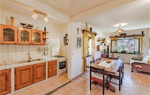 a kitchen with a table and a dining room at Gorgeous Home In Pupnat With Kitchen in Pupnat