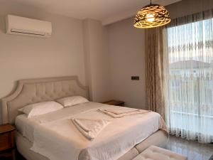 a bedroom with a bed and a large window at ÖZEL HAVUZLU Müstakil LÜKS VILLA in Kusadası +13 photos
