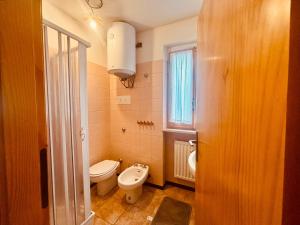 a small bathroom with a toilet and a sink at Romeo House in Campo di Giove +39 photos