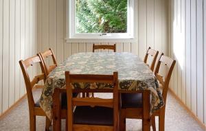 a dining room table and chairs with a table and a window at Gorgeous Home In Øydegard With Wifi in Aspa