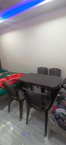 a table and two chairs in a room at Krishna kunj homestay in Ujjain +12 photos