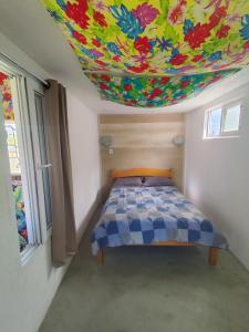 インベーにあるDunas da Imara Casa Brisaのカラフルな天井のベッドルーム1室