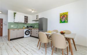 a kitchen and dining room with a table and chairs at Awesome Home In Peroj in Peroj +21 photos