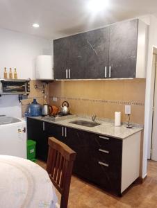 a kitchen with a sink and a counter top at vistas del valle in Villa Carlos Paz