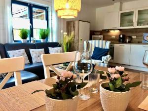 a dining room table with glasses and flowers on it at Herzstück in Tanne
