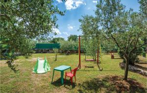 a playground with two chairs and a table at 2 Bedroom Awesome Home In Rovinj in Spanidiga
