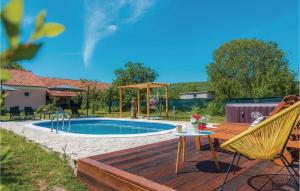 a deck with a table and chairs next to a pool at Awesome Home In Unesic in Unešić +32 photos