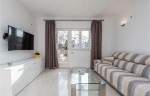 a living room with a couch and a tv at Amazing Home In Vrsi With Wifi in Vrsi
