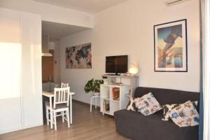 a living room with a couch and a table at Mare e Relax 1 Melody Sea Front 10' da FCO Airport in Fiumicino