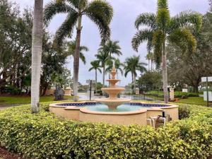a fountain in a park with palm trees at Beach More Getaway in Vero Beach
