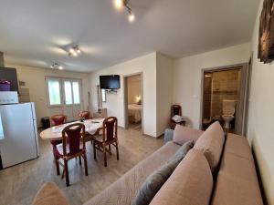 a living room with a couch and a table at APARTMA in SOBE PILIH in Vipava