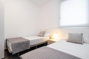 Posteľ alebo postele v izbe v ubytovaní Hauzify I Apartaments Roques Daurades