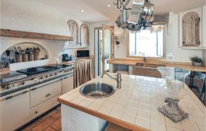 a kitchen with a sink and a stove and a counter at Awesome Home In Les Adrets D L'estérel in St Jean de l’Esterel
