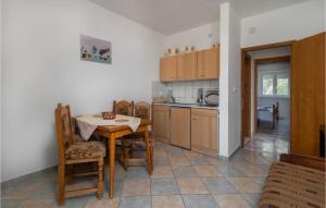 a kitchen with a table and chairs in a room at 4 Bedroom Nice Apartment In Sveti Juraj in Sveti Juraj