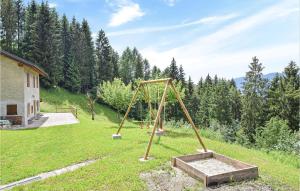 an empty swing set in a field with trees at Casa Giglio Rosso in Sovramonte