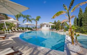 a pool at a resort with chairs and umbrellas at Amazing Apartment In Ricadi in Ricadi