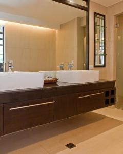 a bathroom with two sinks and a large mirror at The District Boracay in Boracay