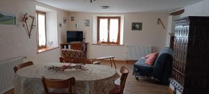 a living room with a table and a couch at Gite sur le Mont in Lapoutroie
