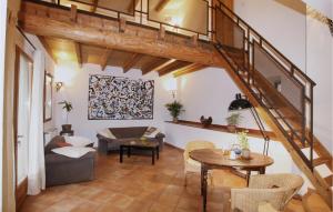 a living room with a staircase with a couch and a table at Lovely Home In Malataverne in Malataverne