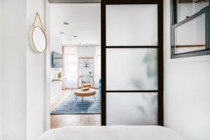 a bedroom with a door leading to a living room at 69-3B Celebrate in Style 1BR Prime Lower East Side Brand New in New York