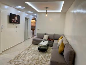 a living room with a couch and a table at Apartment Haut Standing in Agadir