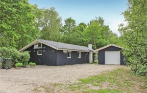 a black house with a white garage at Lovely Home In Glesborg With Wifi in Fjellerup +19 photos