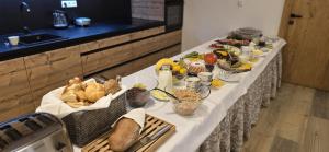 een lange tafel met veel eten erop bij Apartment Draco in Harrachov +58 foto's