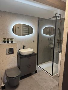 a bathroom with a sink and a shower at Apartament Centro 9 in Leszno +20 photos
