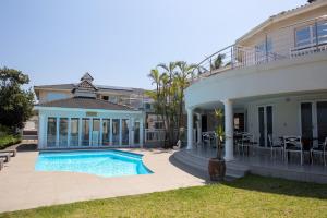 a house with a swimming pool in front of it at Boathouse Ballito in Ballito