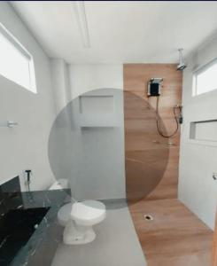 a bathroom with a toilet and a glass wall at Imóvel COP30 - Próximo parque da Cidade in Belém