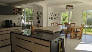 une cuisine et une salle à manger avec une table et des chaises dans l'établissement Oxyzenvilla 34800 Lacoste, à Lacoste