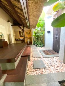 a house with a walkway leading to a patio at Villa Purnamasari in Ubud