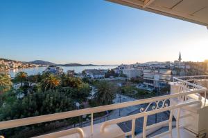 a balcony with a view of the water and buildings at Hotel Myrtai - City Center in Sarandë