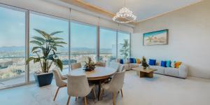 a living room with a table and chairs and windows at Maritima Playa Luxury Condo 6O in Bucerías