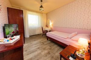Postel nebo postele na pokoji v ubytování Hotel Freizeittempel