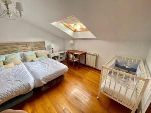 a bedroom with a bed and a desk with a table at Apartamento duplex en Ojedo in Ojedo