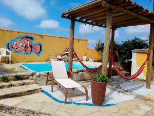 a playground with a slide and a monkey painting on a wall at Recanto das Pedras - Loft Container in São Thomé das Letras