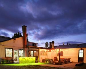 a house with a lit up patio in front of it at Hostel Argentino & camping in Río Grande