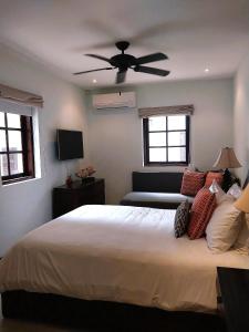 a bedroom with a bed with a ceiling fan at Las Catalinas - Studio Cazenovia centrally located, short walk to beach in Playa Danta