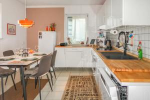 a kitchen with a table and a white refrigerator at Homestay - Stilvolle Wohnung in Büdingen in Büdingen