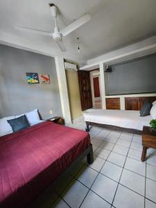 a bedroom with a large bed and a ceiling fan at Casa Damian in Puerto Vallarta +22 photos