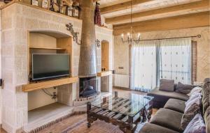 A television and/or entertainment centre at Beautiful Home In Sant Miquel Daro