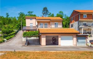 a house with an orange roof and a garage at Awesome Apartment In Bresca in Breza