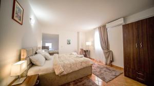 a bedroom with a large bed with pillows on it at Hotel Damar family room in Međugorje
