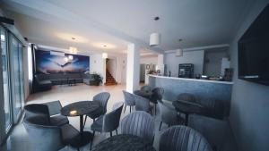 a restaurant with chairs and tables in a room at Hotel Damar family room in Međugorje